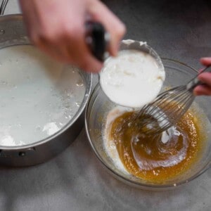 tempering eggs and sugar with hot milk