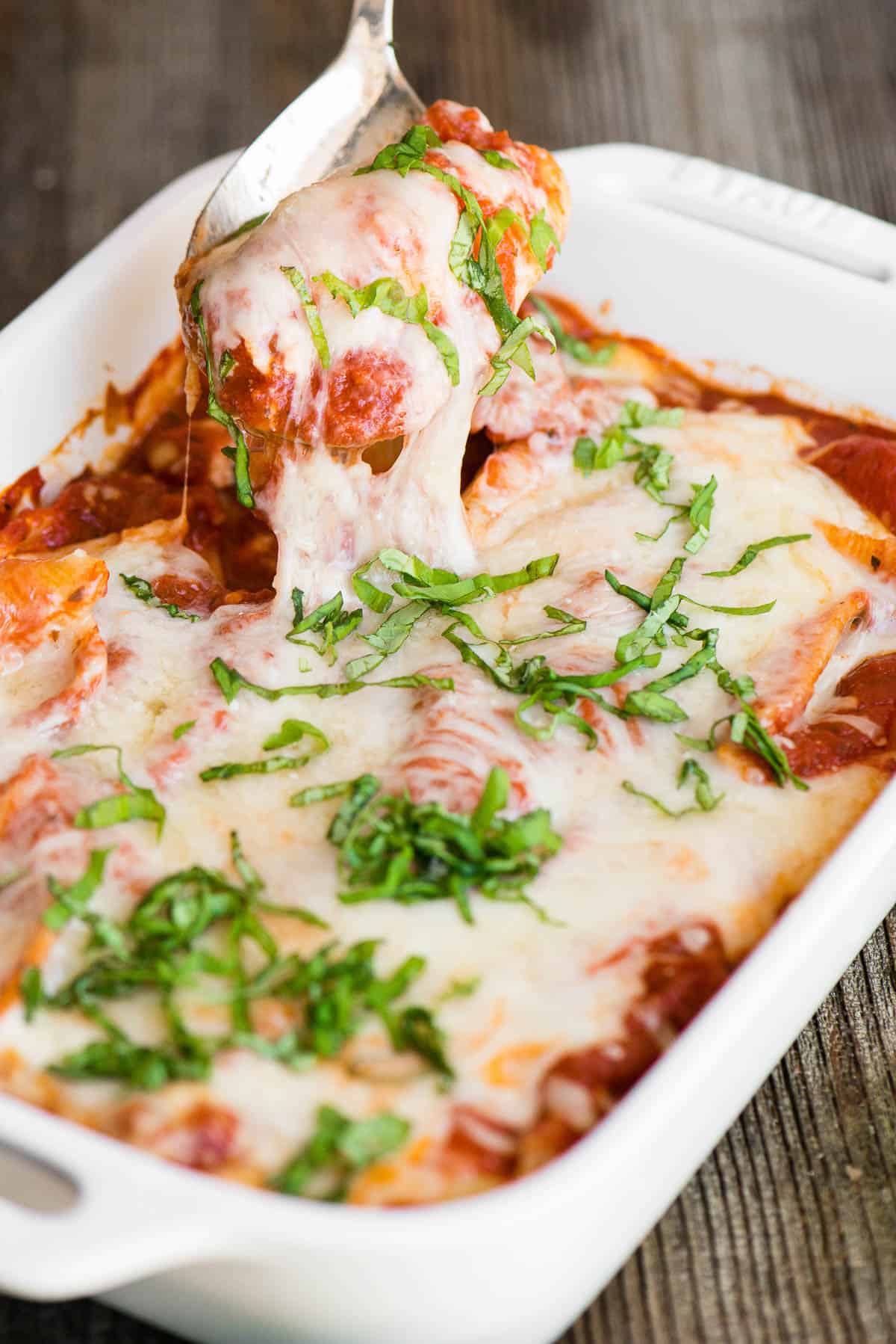 pan of ricotta stuffed shells with cheese and sauce