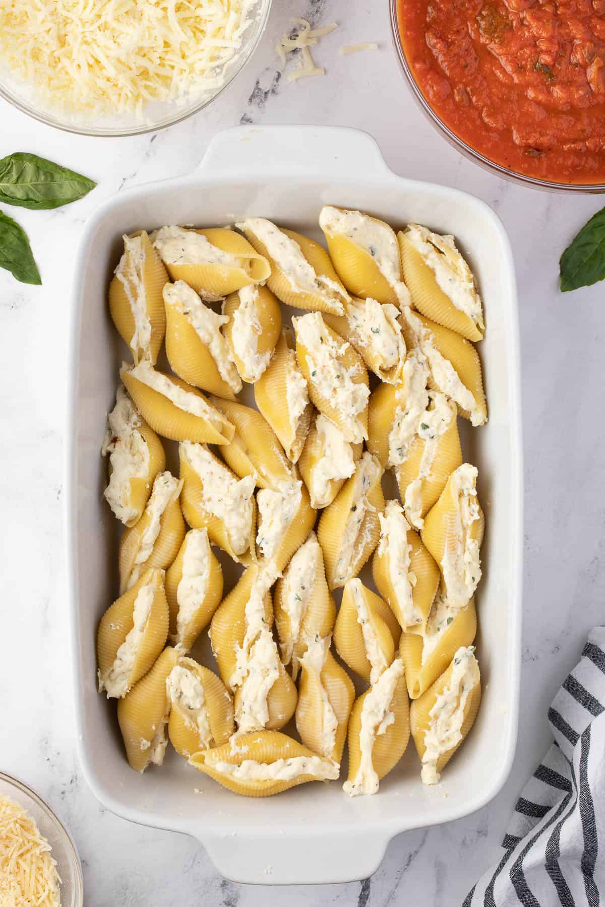 pasta shells filled with soft cheese in casserole dish