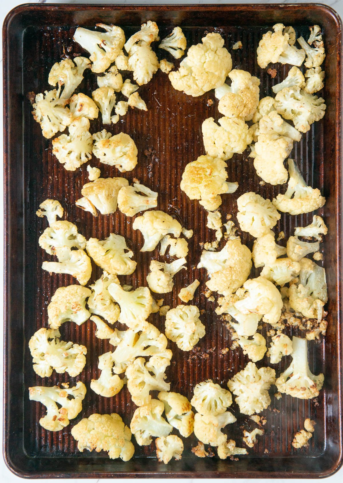 baking sheet with roasted cauliflower florets.