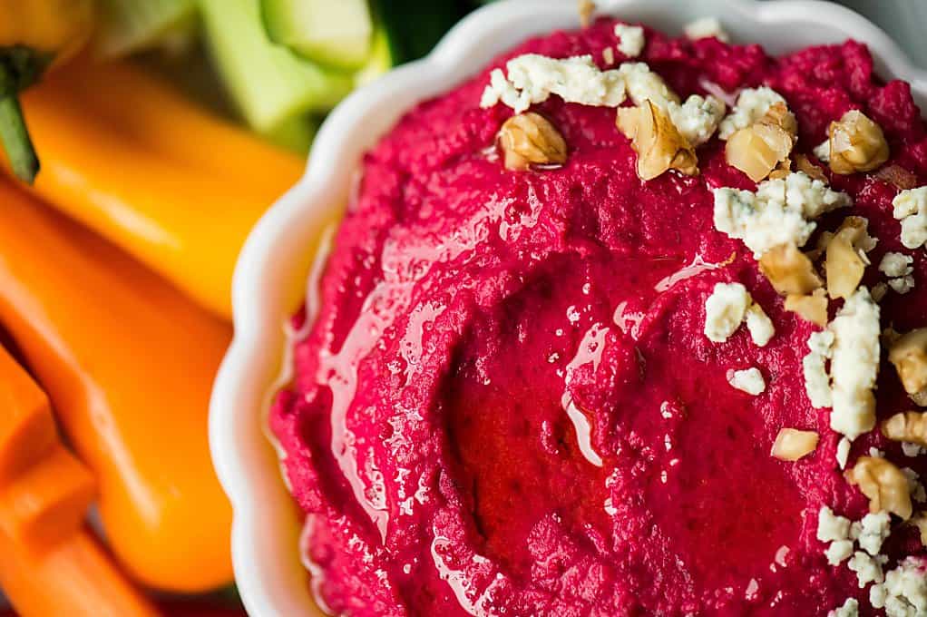 garlic beet hummus in a white dish