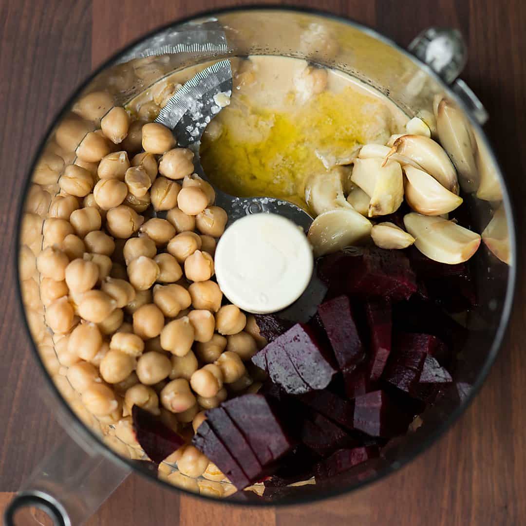 ingredients for roasted garlic beet hummus preblended in a blender