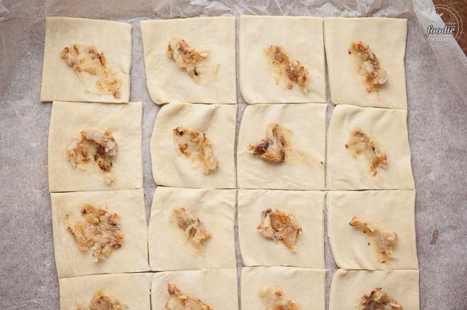 puff pastry squares topped with roasted garlic