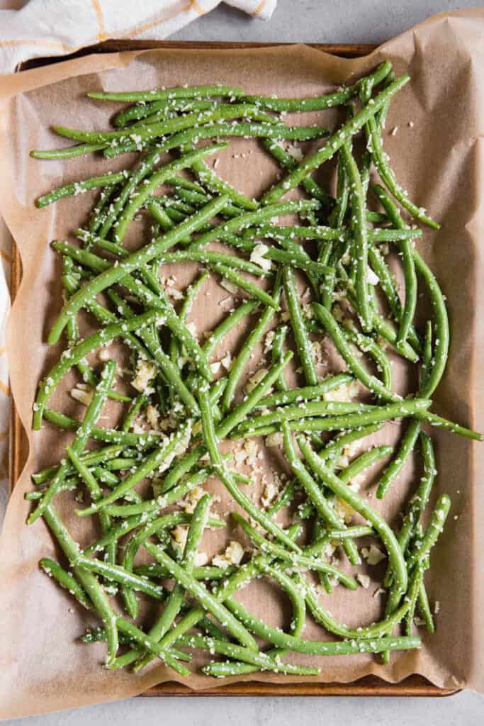 green beans and garlic on parchment paper.