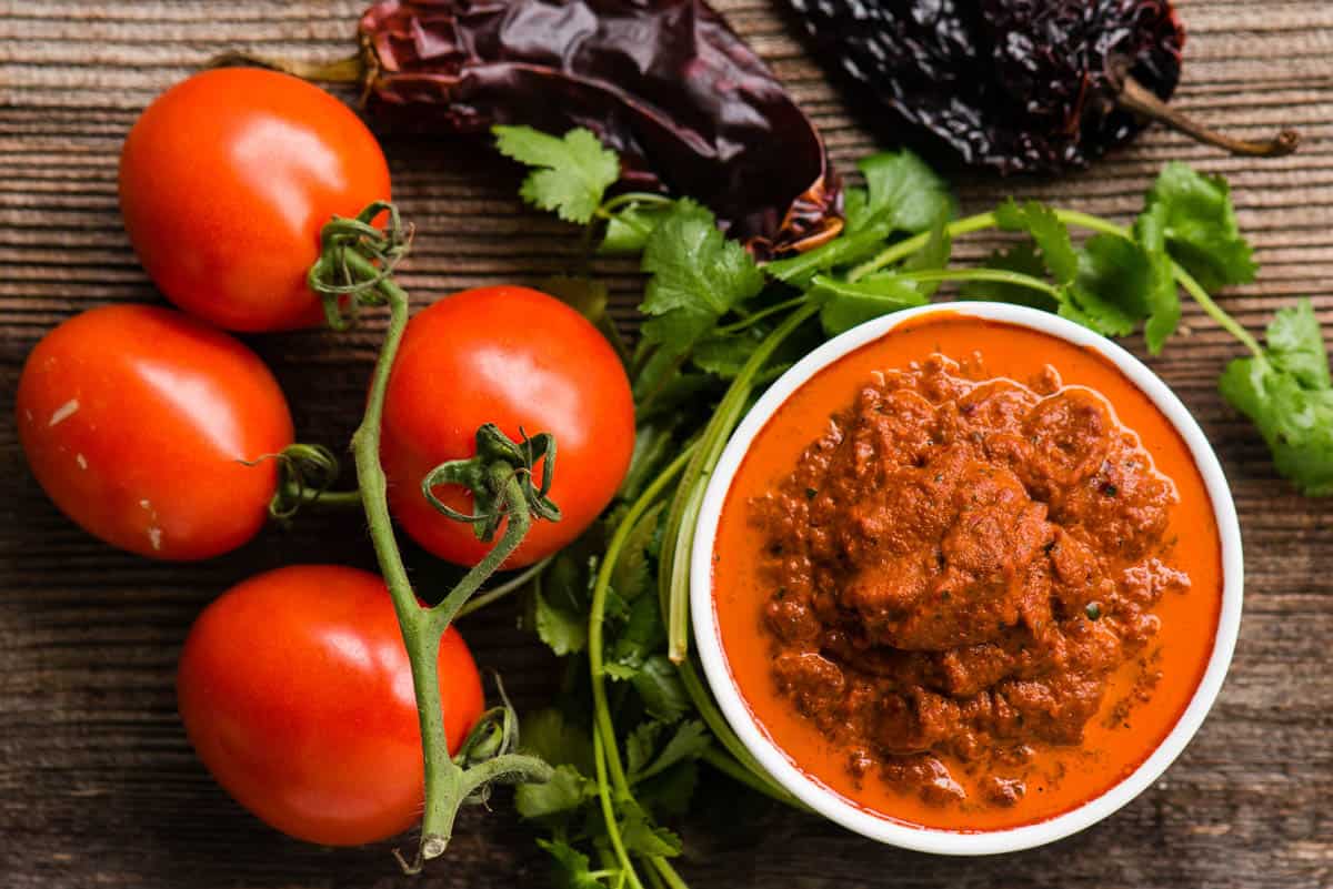 homemade salsa roja in white dish with dried chiles and tomatoes.