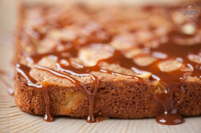 A close up of the side of a fresh apple cake with caramel sauce