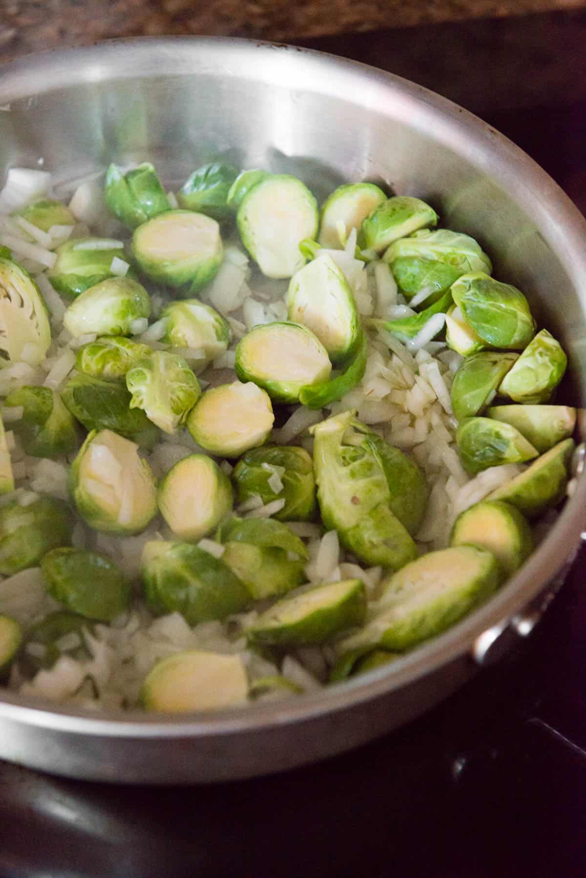 Brussels Sprouts and onions cooking in pan