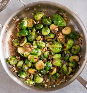 browned Brussels Sprouts with onion and pine nuts in pan