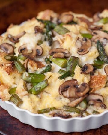 This Savory Bread Pudding with mushrooms, asparagus, and your favorite cheese is a delicious make ahead breakfast perfect for entertaining!