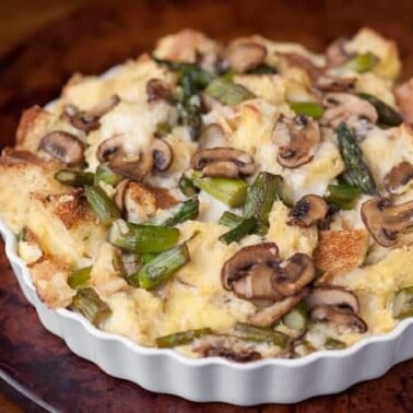 This Savory Bread Pudding with mushrooms, asparagus, and your favorite cheese is a delicious make ahead breakfast perfect for entertaining!