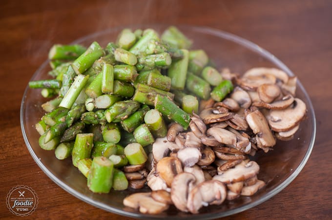 mushrooms and asparagus on a clear plate