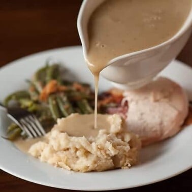 Savory Herb Turkey Gravy is the absolute best homemade turkey gravy from turkey drippings that you can serve with your Thanksgiving dinner.