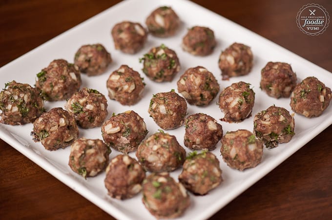 a platter of cooked beef cocktail meatballs