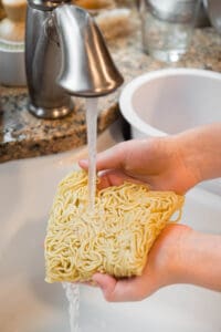 rinsing yakisoba noodles under running water