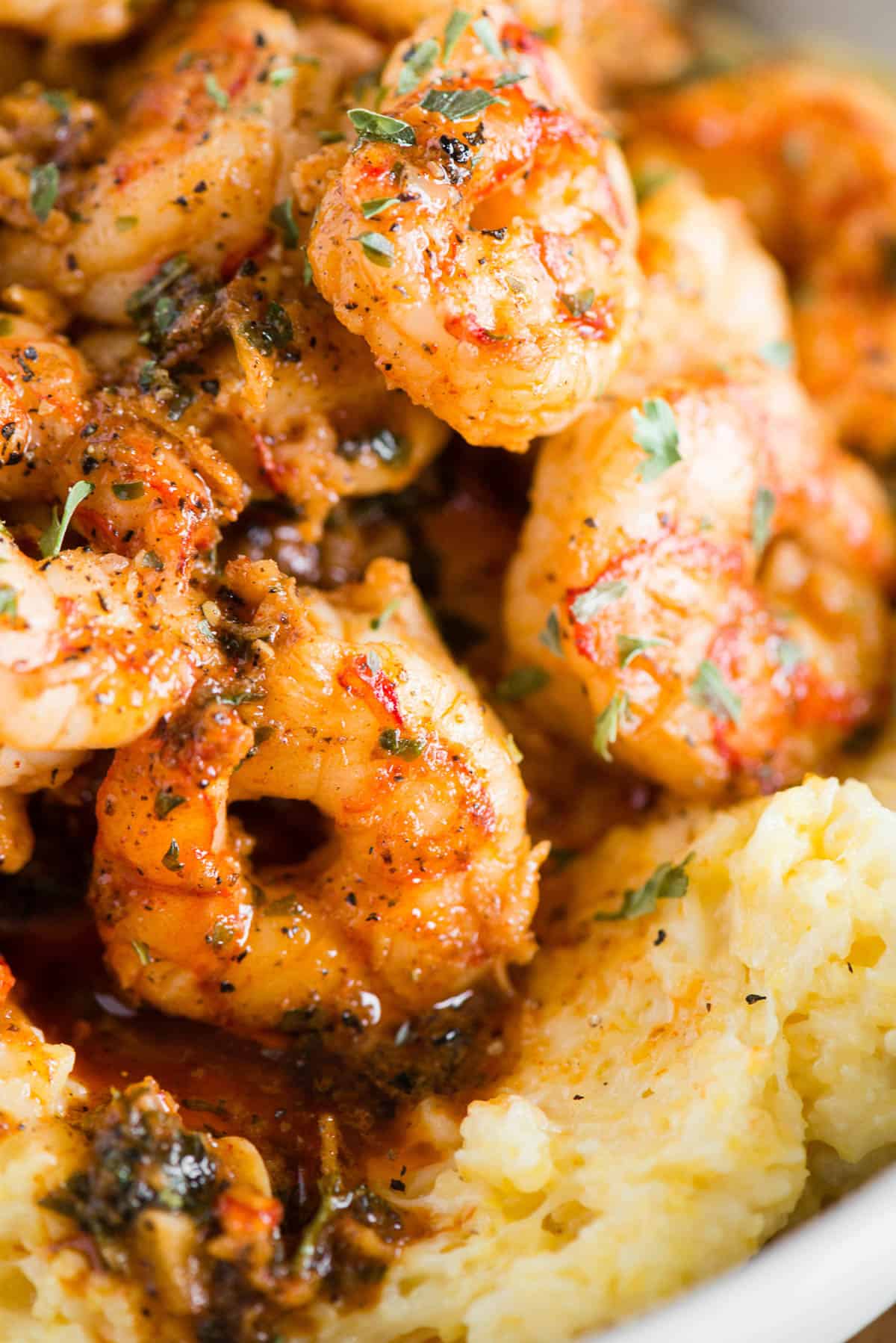 seared shrimp with parsley and pan sauce piled over cheesy grits