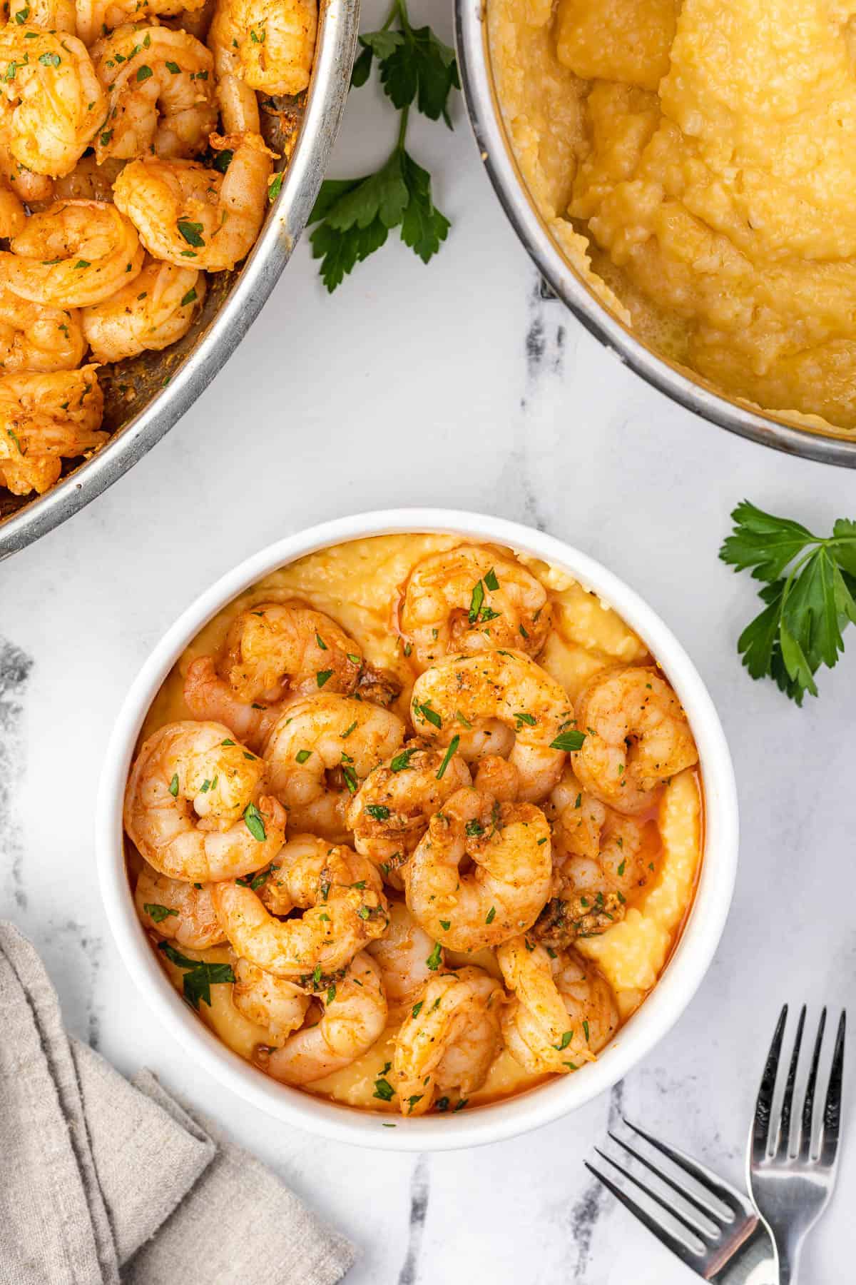 shrimp and pan sauce served over cheese grits in a bowl