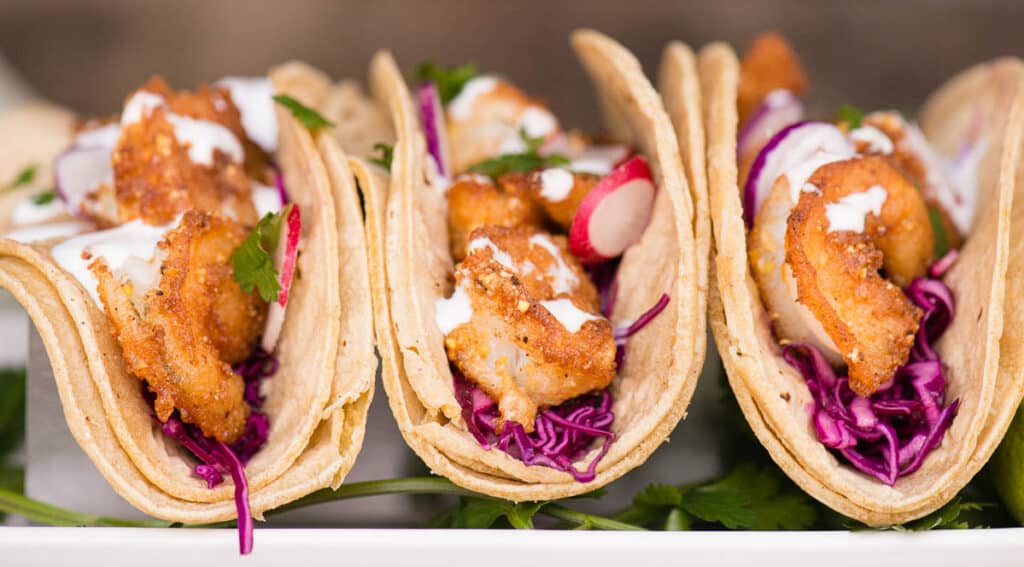 Shrimp Tacos with coleslaw and crema