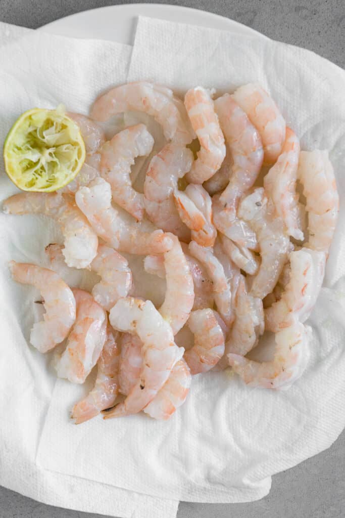 raw shrimp on paper towel lined plate