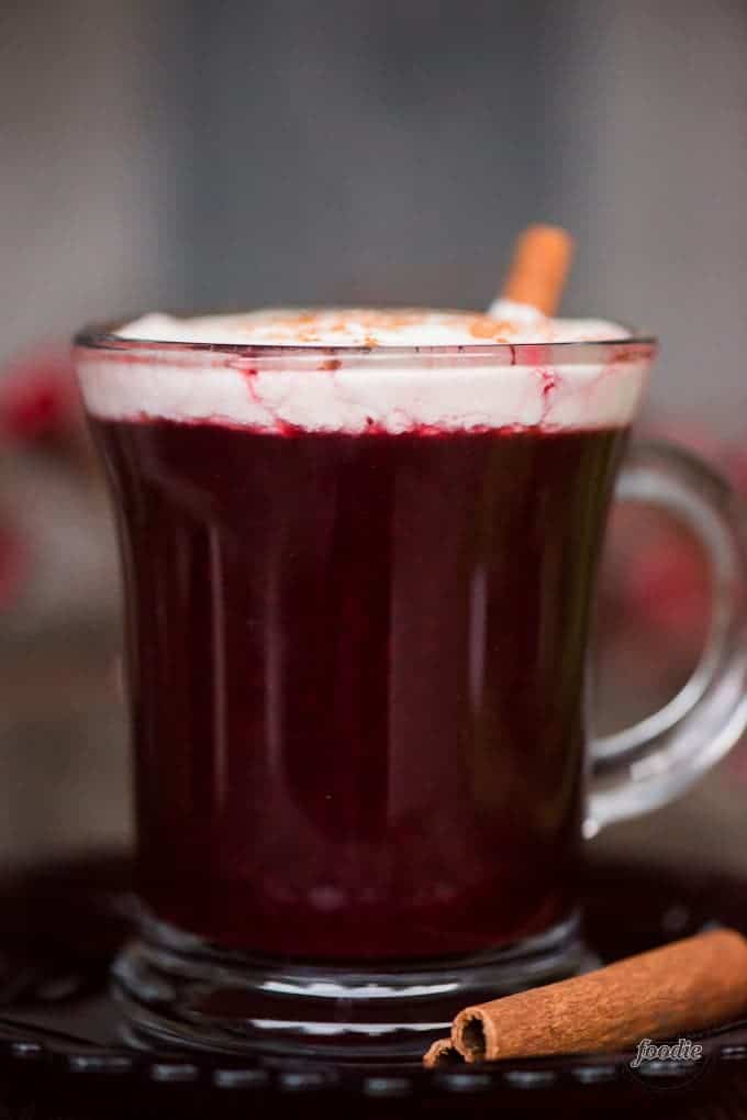 glass mug of berry cider with whipped cream