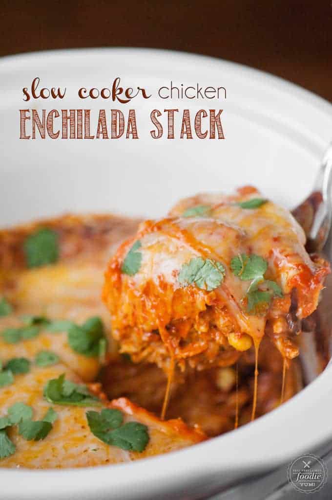 scooping chicken enchiladas out of slow cooker