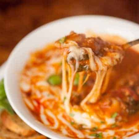 Enjoy all the comfort of lasagna in this light and easy to make sausage, mushroom, spinach Slow Cooker Lasagna Soup topped with melted mozzarella cheese.
