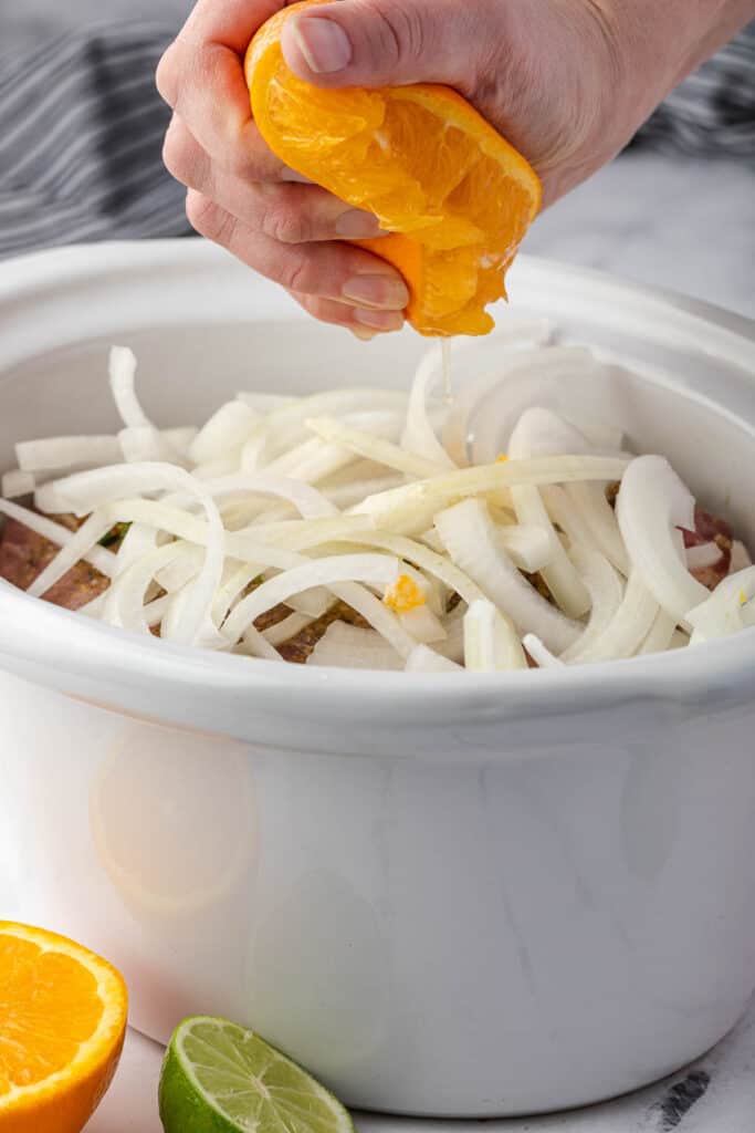 squeezing orange over onions