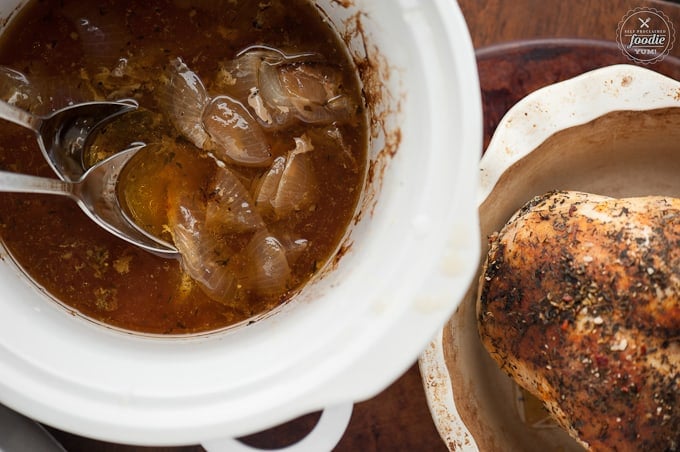 Crock pot with liquid and onions after cooking turkey