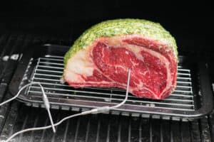 prime rib in smoker with thermometer