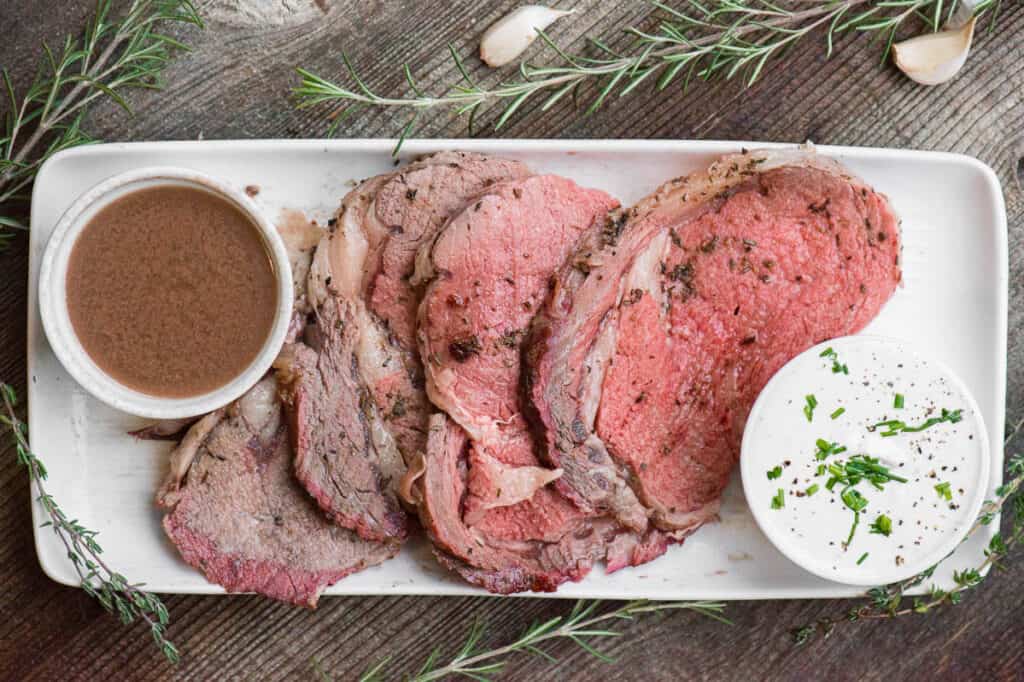 sliced prime rib with au jus and horseradish sauce