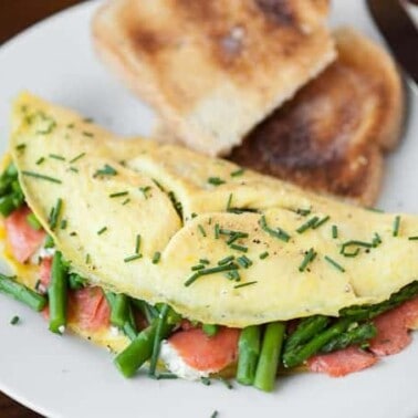 If you're looking for a new way to enjoy your eggs at breakfast, this Smoked Salmon Asparagus Goat Cheese Omelet tastes outstanding and is full of protein.