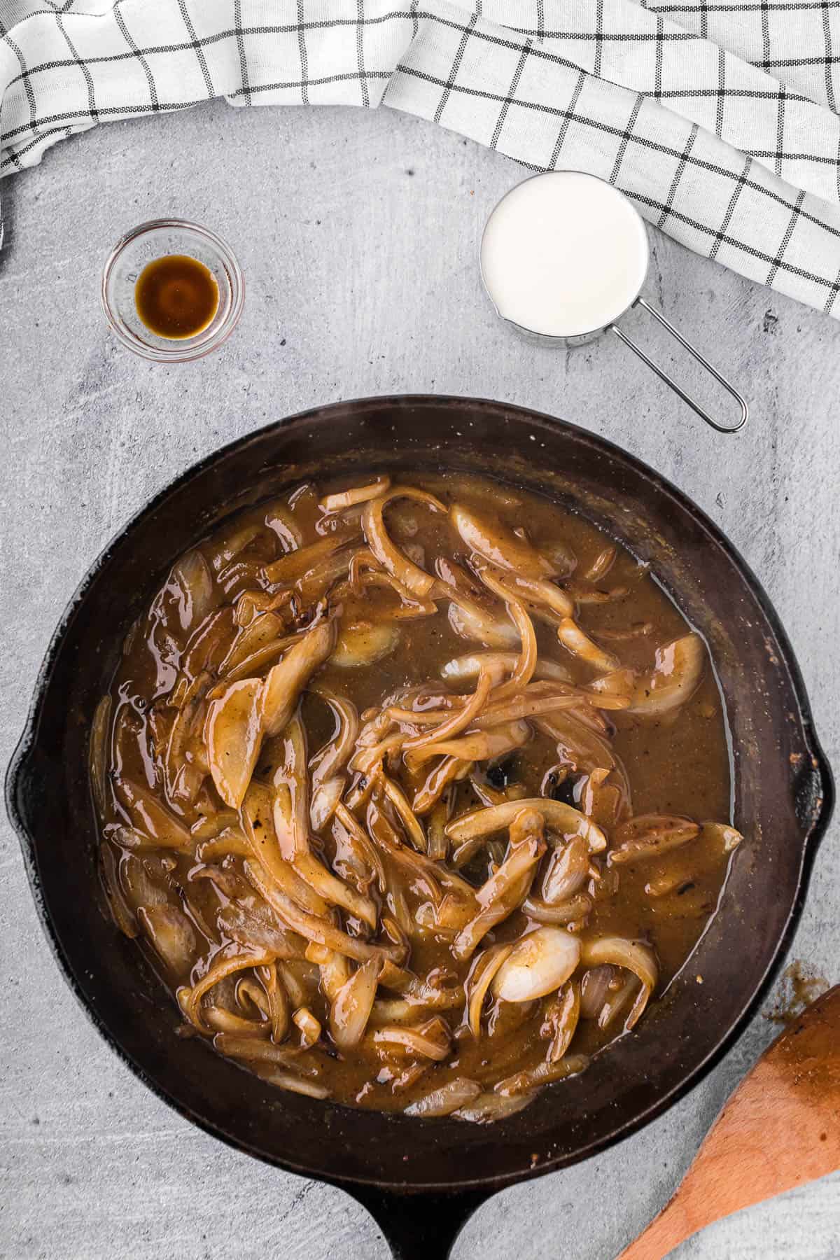 onion gravy in cast iron skillet for smothered chicken recipe.