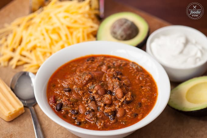 chili with ground beef, chorizo, black and pinto beans in white bowl