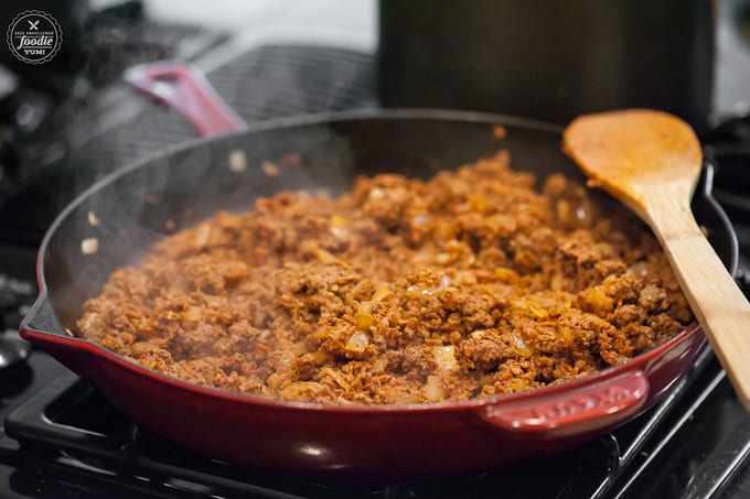 ground beef, onion, and chorizo in pan on stove