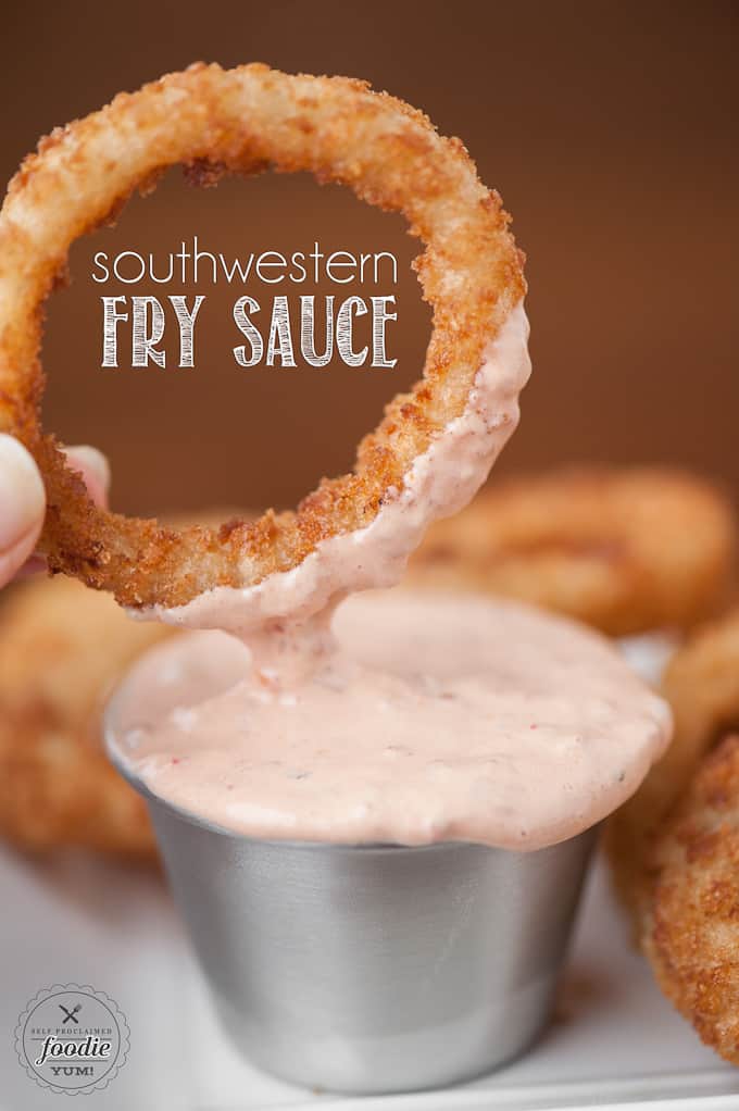 dipping an onion ring into Fry sauce