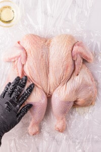 rubbing oil on hole chicken