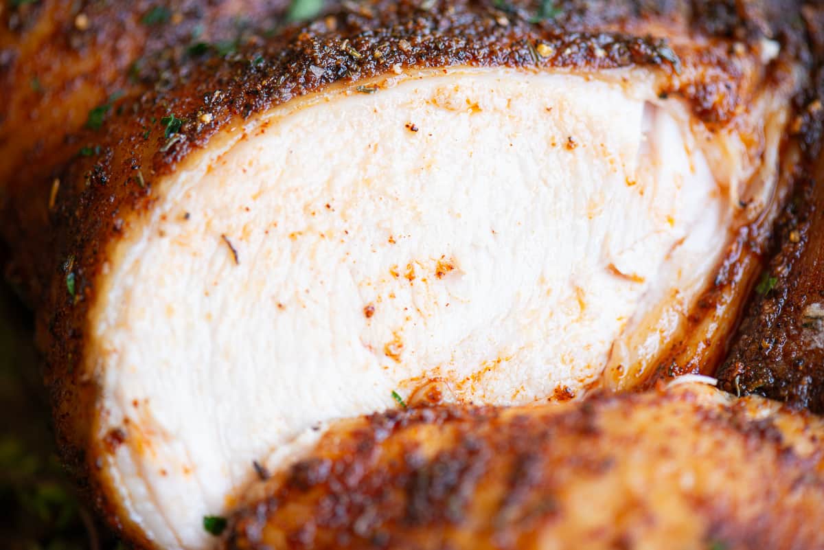 close up of chicken breast with seasoned crispy skin