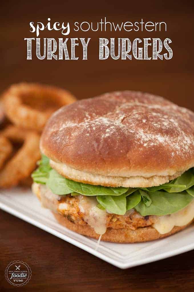 A close up of a turkey burger with cheese and fresh spinach