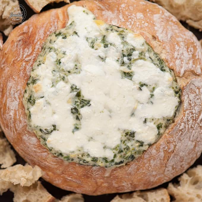 cheese dip with spinach and artichokes in a homemade bread bowl