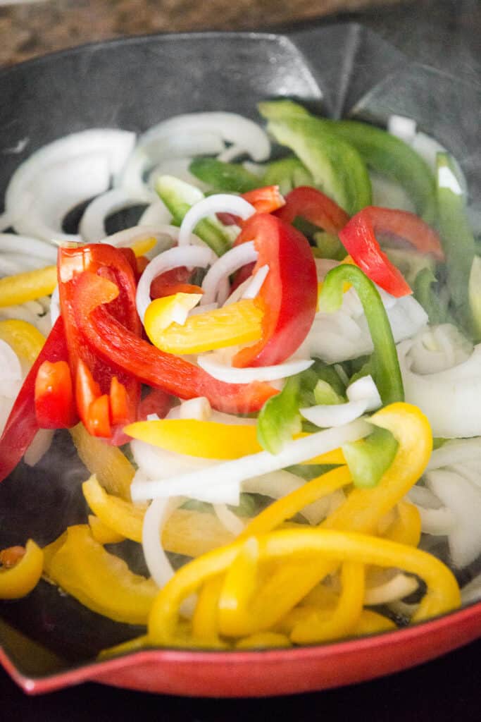 sliced onions and peppers in pan