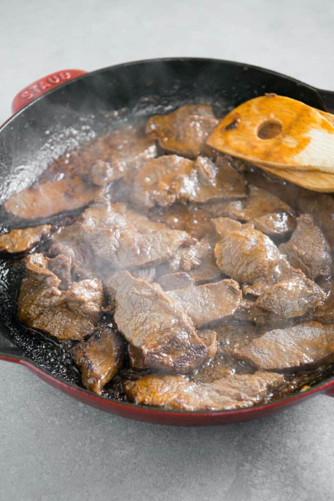 marinated sliced steak in pan