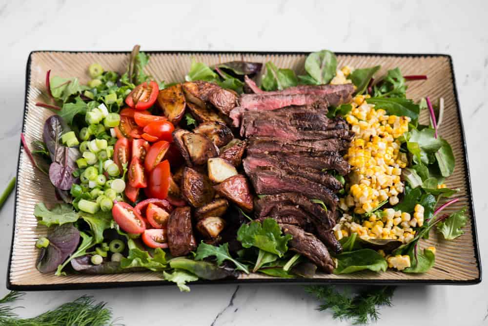 Flat Iron Steaks with Grilled Corn and Cumin-Lime Butter