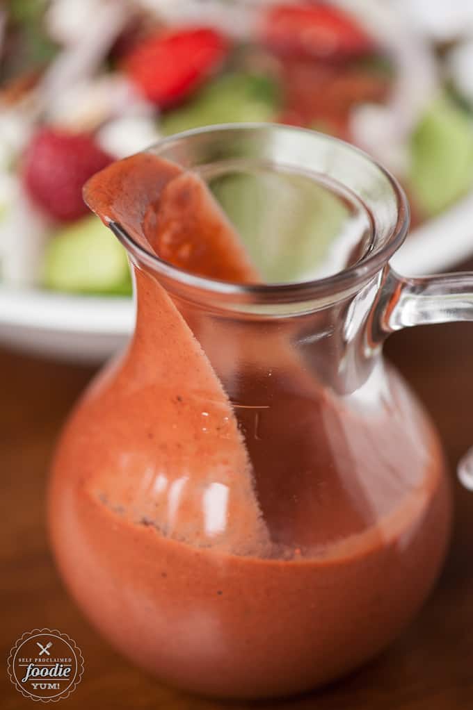 a pitcher with strawberry basil vinaigrette