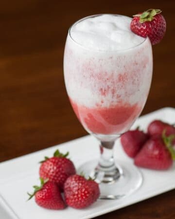 This blended non-alcoholic Strawberry Coconut Lava Flow made with fresh strawberries, pineapple juice and coconut cream is the perfect tropical mocktail.