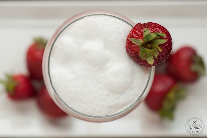 looking down at coconut drink with strawberry