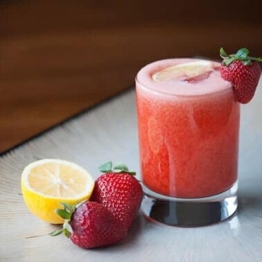 This blended Strawberry Lemonade Whiskey Sour is perfectly tart and sweet with a bourbon whiskey kick is the perfect summertime cocktail.