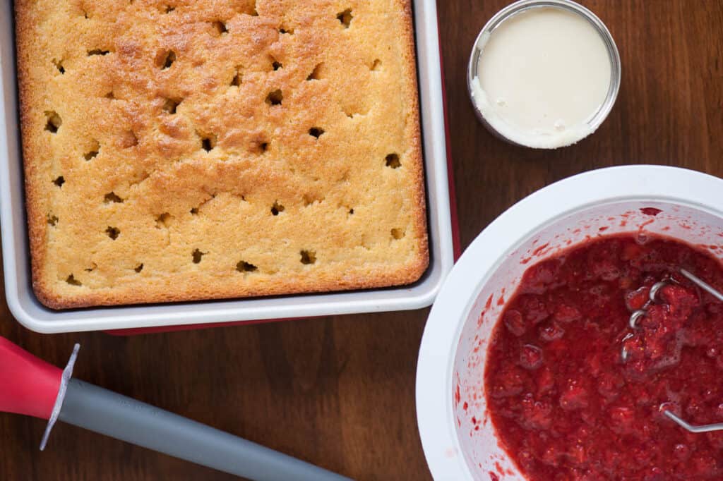 vanilla poke cake with strawberries and cream