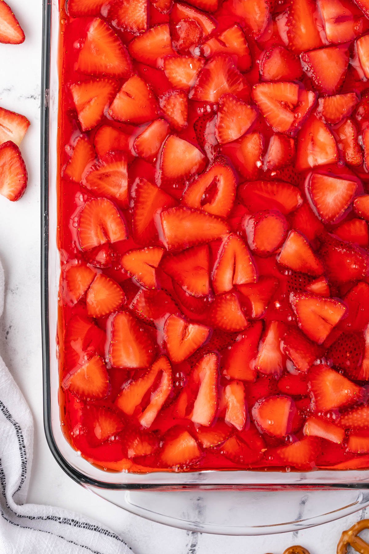 sliced strawberries in strawberry jello.