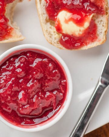 homemade strawberry rhubarb jam on buttered biscuit