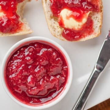 homemade strawberry rhubarb jam on buttered biscuit