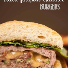 A close up of a stuffed bacon jalapeno cheddar burgers
